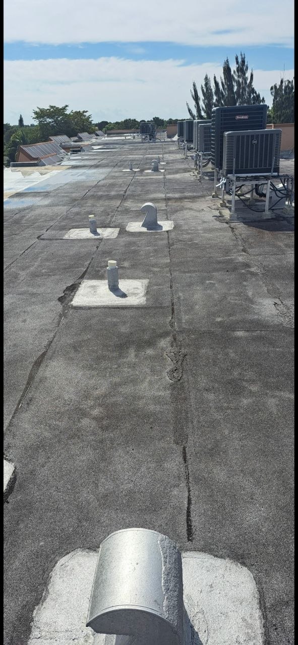Flat commercial roof inspection with HVAC units in South Florida