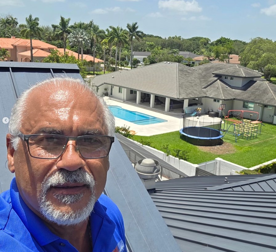 Angel from Primetime Property Inspections on a roof in South Florida